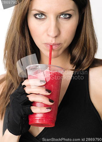 Image of Girl with Refreshing Red Fruit Smoothie after Gym Workout