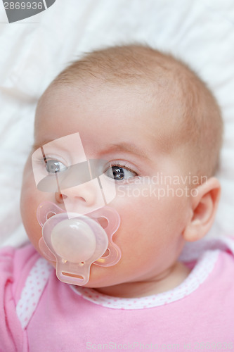 Image of adorable baby with pacifier