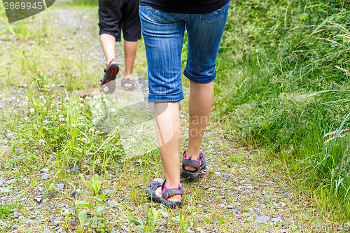 Image of Woman walking with son cross country
