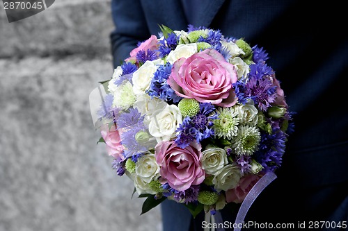 Image of groom holding a bouquet