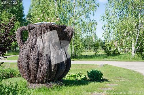 Image of pitcher weaved from dried birch branches  