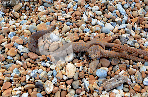 Image of Rusty hook and cable on shingle