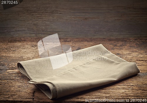 Image of linen napkin on wooden table