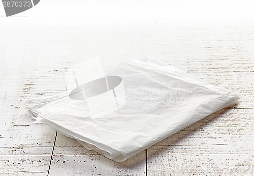 Image of white wrapping paper on wooden table