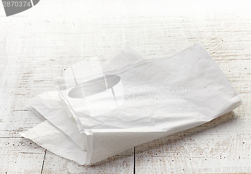 Image of white wrapping paper on wooden table