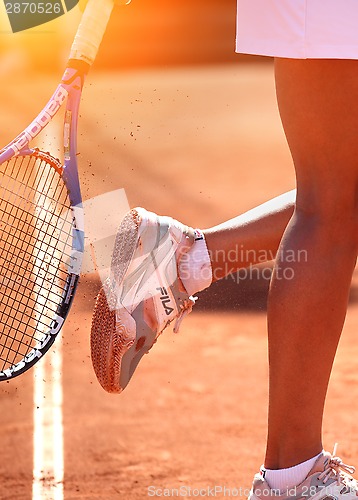 Image of female tennis player on tennis court