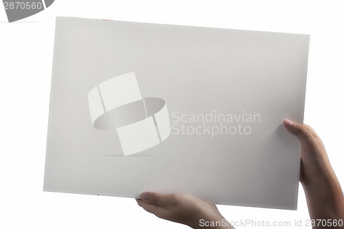 Image of White Plastic laminate sign held up by hands