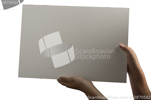 Image of White Plastic laminate sign held up by hands