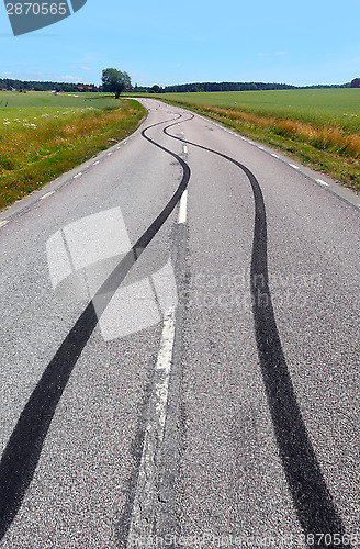 Image of Tire print on the asphalt road