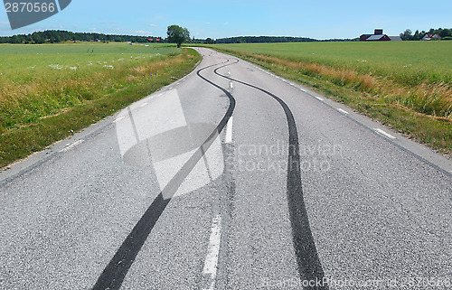Image of Tire print on the asphalt road 