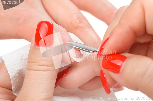 Image of manicure applying - cleaning the cuticles 