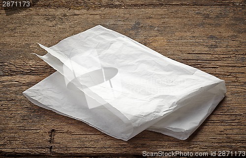 Image of white wrapping paper on wooden table