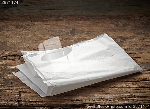 Image of white wrapping paper on wooden table