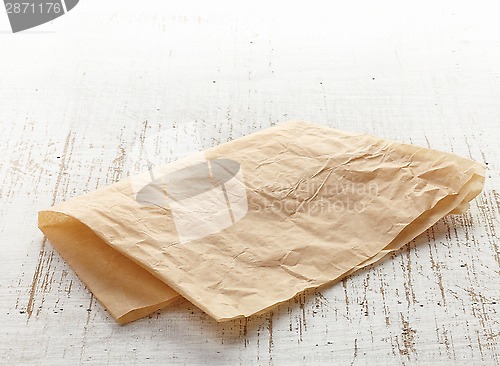 Image of brown wrapping paper on wooden table