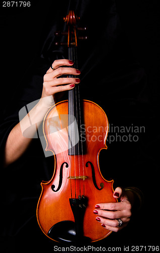 Image of Female Violinist Holds Bow Across Saturated Musical Violin Acous