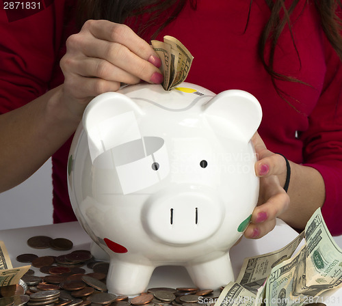 Image of Woman Fills Savings Piggy Bank American Currency Cash Coins Weal