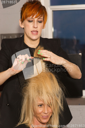 Image of Stylist Combs Out Hair Model During Artwalk Event Salon Tacoma