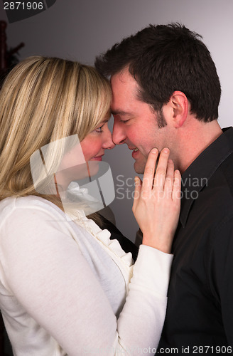 Image of Young Couple Man Woman Engaged Standing Hugging Kissing Embracin
