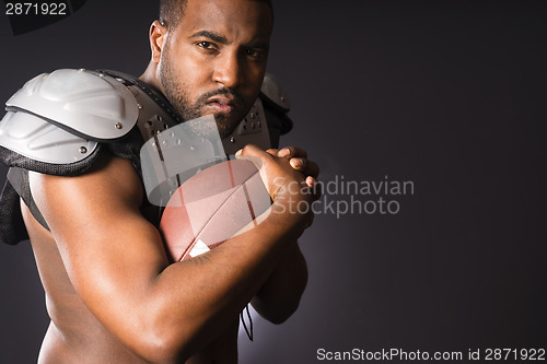 Image of Angry African American Male Football Player Holds Ball Tight