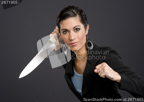 Image of Woman in Business Jacket Wields Large Kitchen Knife Back Stabber