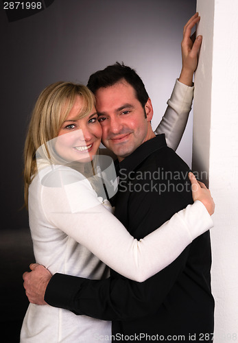 Image of Young Couple Man Woman Engaged Standing Hugging Kissing Embracin