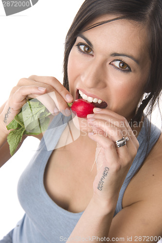 Image of Beautiful Brunette American Woman Enjoys the Taste of Radish