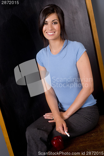 Image of University Teacher Sits on Desk Blackborad Apple Chalk