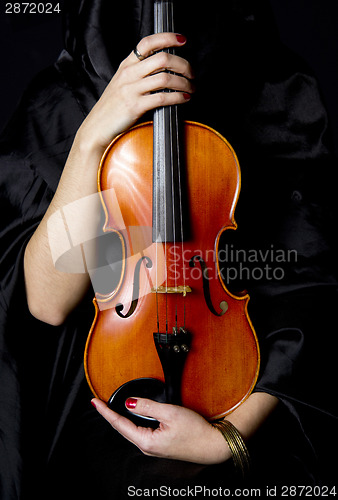Image of Important Violin Held in Manicured Hands