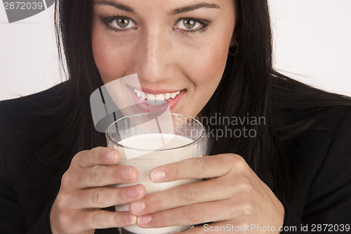 Image of Attractive Young Woman Drinks Whole Milk From a Glass