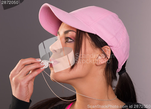 Image of Attractive Brunette Female Blows Whistle Pink Ball Cap Whistlebl