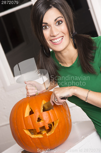 Image of Excited Happy Woman Cutting Carving Halloween Pumpkin Jack-O-Lan