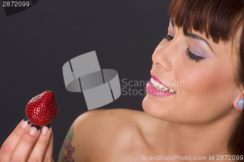 Image of Attractive Woman Holding a Strawberry