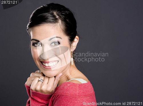 Image of Pretty Woman in a red sweater looking at the camera