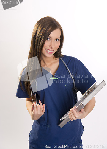 Image of Beautiful Brunette Nurse Holds Patient Medical Chart Data in Cli