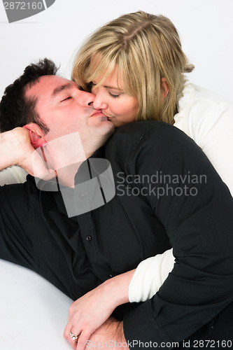 Image of Young Couple Man Woman Engaged Laying Down Kissing Embracing