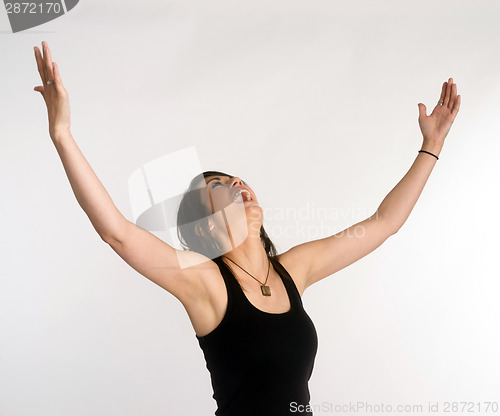 Image of Pretty Brunette Woman Holds Arms Outstretched Jubilant Looking U