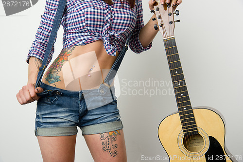 Image of Attractive Woman's Torso Holding Guitar
