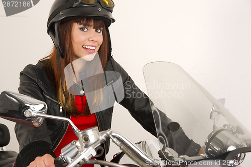 Image of Beautiful Brunette Biker Holding the Handlebars