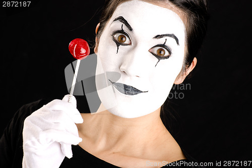 Image of Beautiful Brunette Woman Mime Holds Lollipop Candy White Face