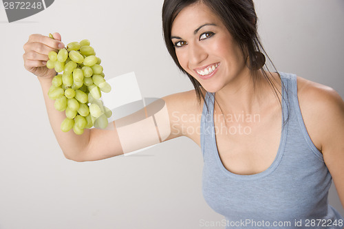 Image of Wholesome Woman Holds Cluster of Beautiful Fruit Food Grapes