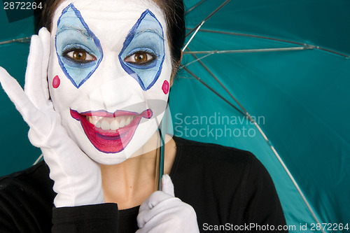 Image of Excited Clown in White Face Holds Umbrella