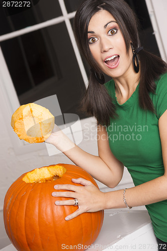 Image of Excited Happy Woman Cutting Carving Halloween Pumpkin Jack-O-Lan