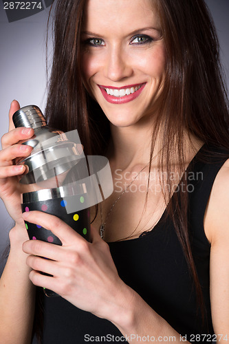 Image of Young Attractive Female Bartender Smiling Mixes Martini Drink Sh