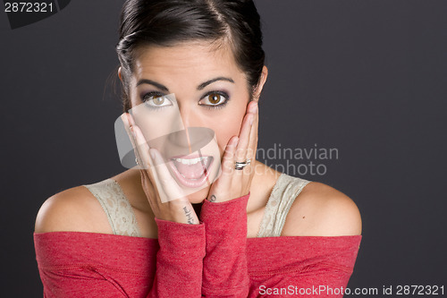 Image of Surprised Brunette Woman Looks at Camera Red Sweater