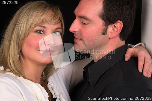 Image of Young Couple Man Woman Engaged Standing Hugging Kissing Embracin