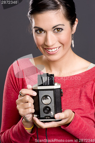 Image of Pretty woman in Red with vintage field camera