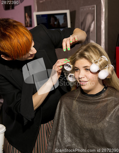 Image of Stylist Positions Curlers On Model During Artwalk Event Salon Ta