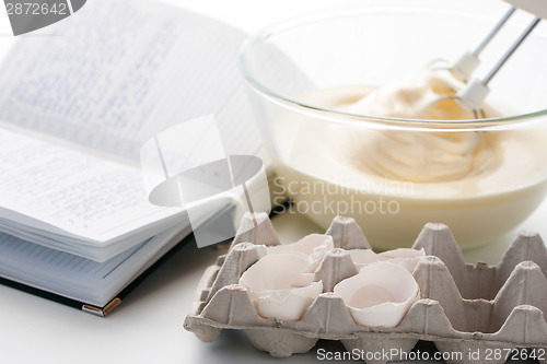 Image of Whisk with eggs in a bowl