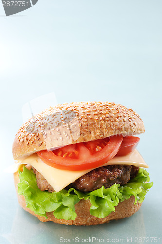 Image of Cheeseburger with tomatoes and lettuce