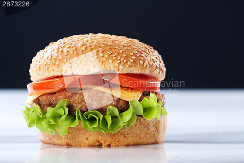 Image of Cheeseburger with tomatoes and lettuce